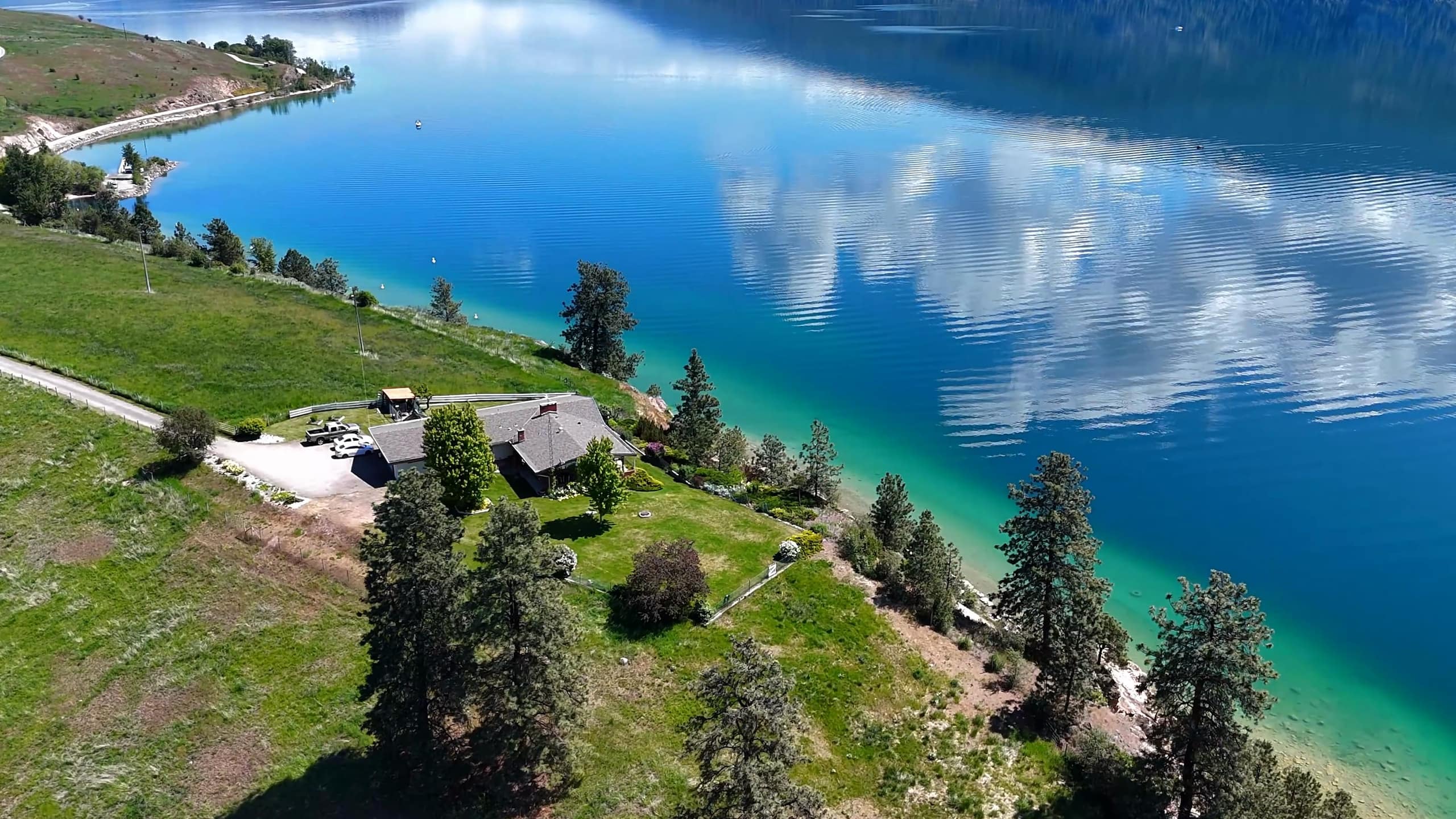 201 Highway 97 from the air: the pasture and house above the turquoise shore of Kalamalka Lake