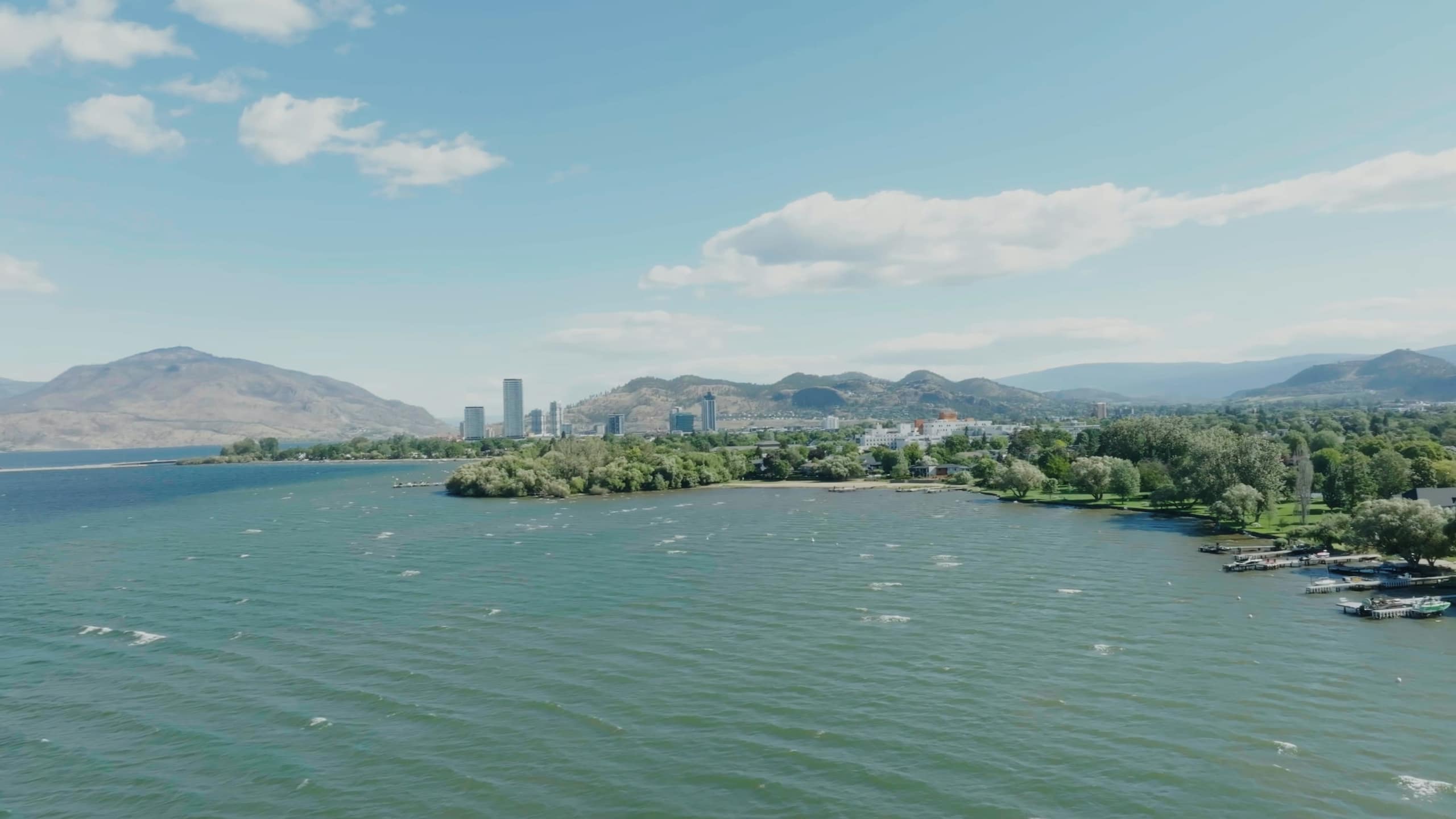Downtown Kelowna's towers across Okanagan Lake, from the shore at 2764 Abbott Street