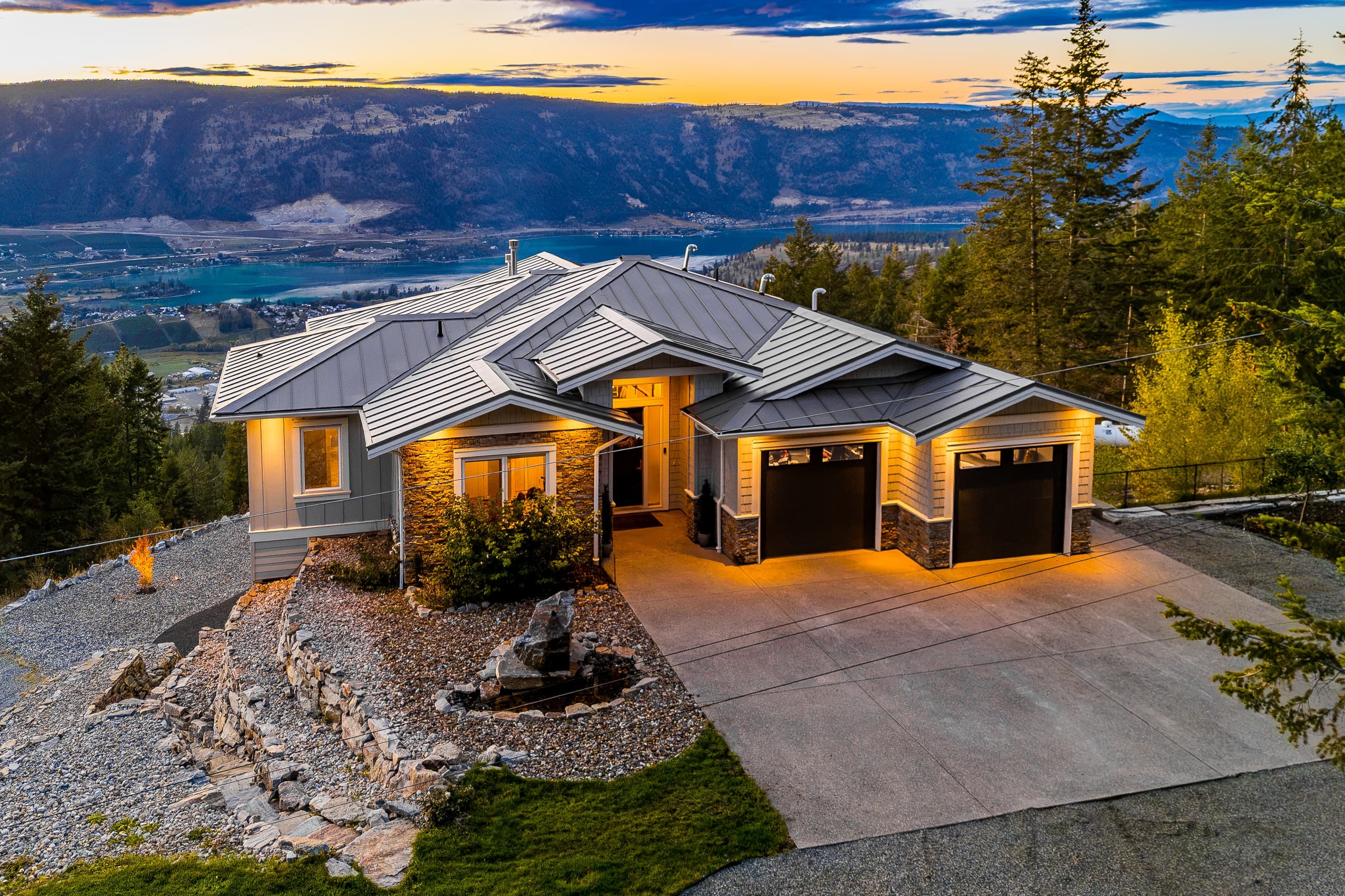 6022 Oyama Lake Road, Lake Country: front of the house at dusk above the valley